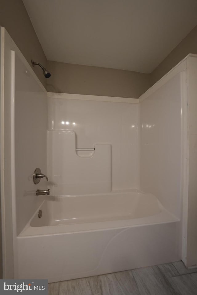 bathroom with hardwood / wood-style floors and shower / bathing tub combination