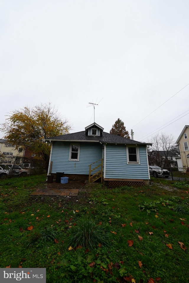 back of house with a lawn and a patio area