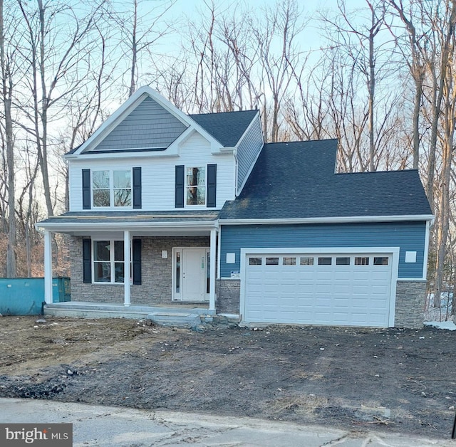 front facade featuring a garage and covered porch