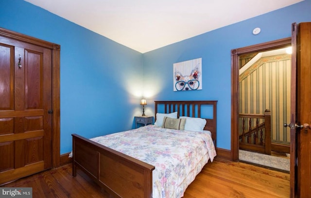 bedroom with hardwood / wood-style flooring