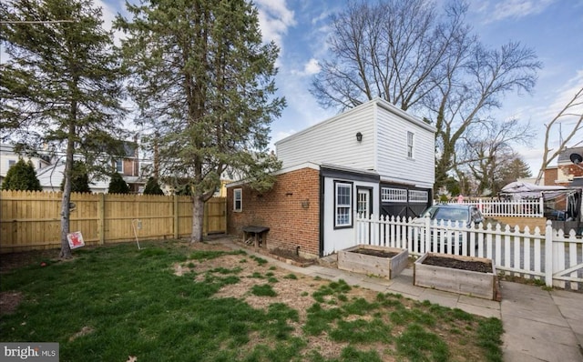 rear view of house with a yard