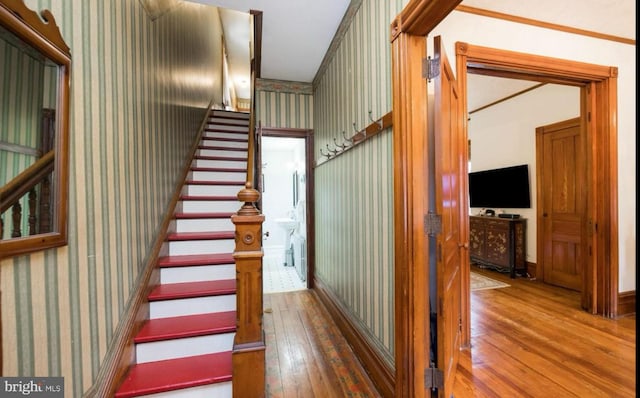 stairs featuring hardwood / wood-style flooring