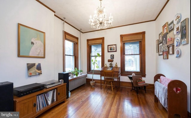 living area featuring an inviting chandelier, dark wood-type flooring, radiator heating unit, and ornamental molding