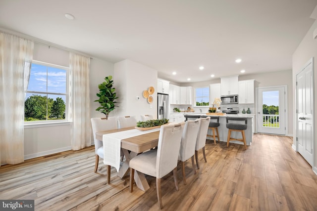 dining area featuring light wood-type flooring