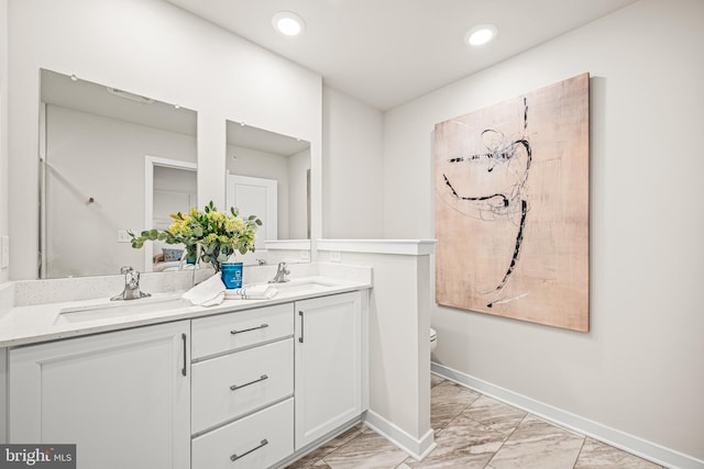 bathroom featuring vanity and toilet