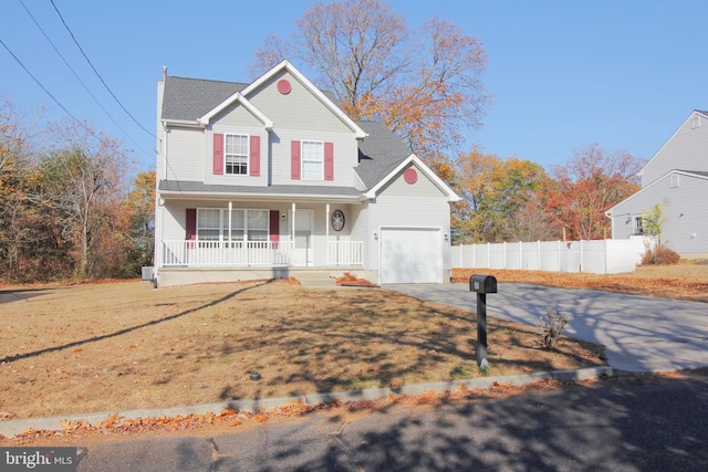 view of property featuring a porch, a garage, and a front yard