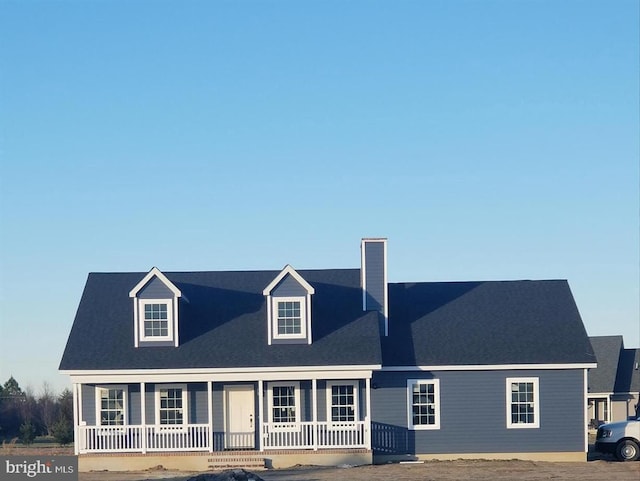 cape cod-style house with a porch