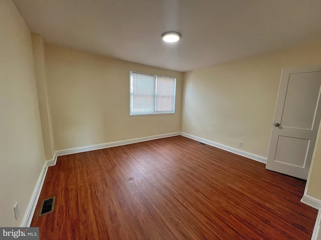 empty room featuring dark wood-type flooring