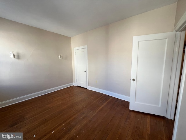 unfurnished room featuring dark hardwood / wood-style floors