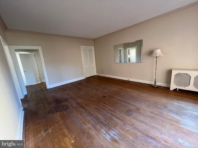 unfurnished bedroom with hardwood / wood-style flooring and ornamental molding