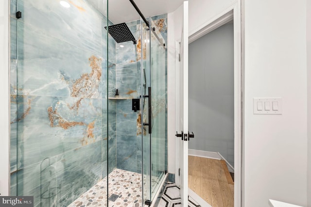 bathroom featuring hardwood / wood-style flooring and an enclosed shower