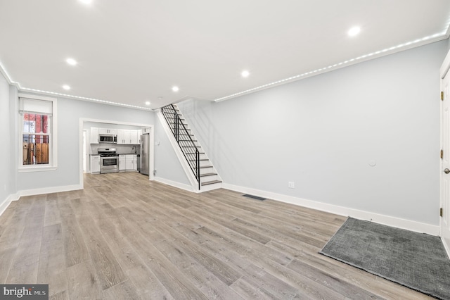 unfurnished living room featuring light hardwood / wood-style floors