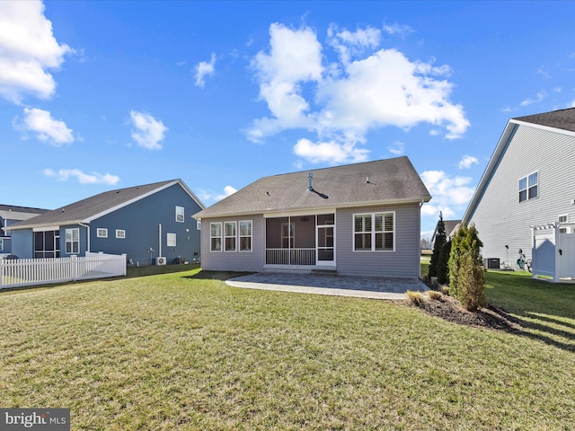 back of property featuring a patio, central AC unit, fence, a sunroom, and a yard