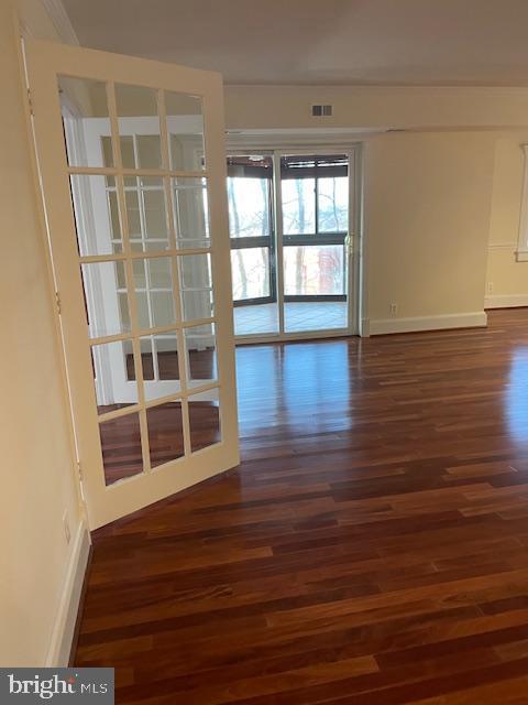 spare room with dark hardwood / wood-style floors