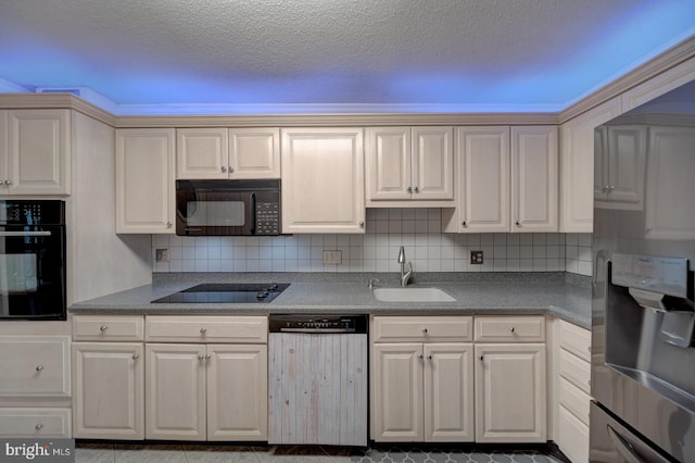 kitchen featuring sink, decorative backsplash, black appliances, and a textured ceiling