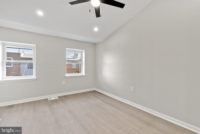 unfurnished room with vaulted ceiling, ceiling fan, and light wood-type flooring