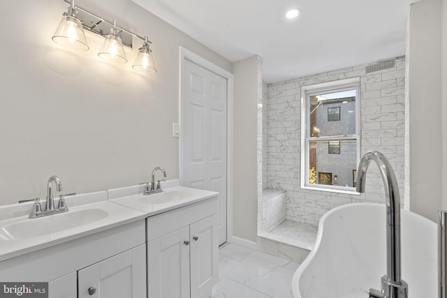 bathroom featuring vanity and a bathing tub