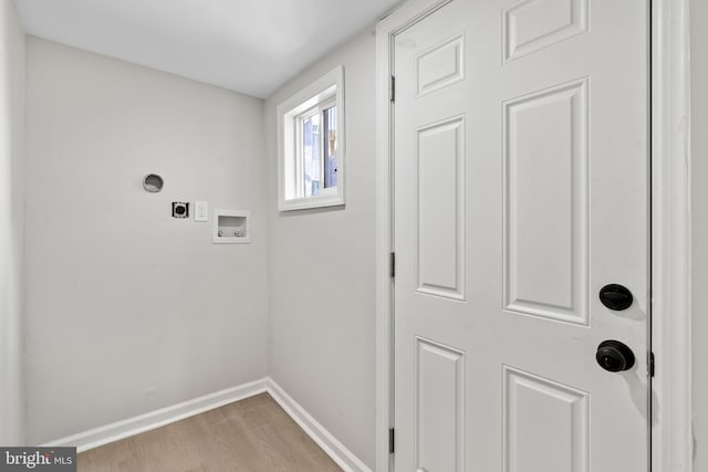 laundry room with hookup for a washing machine, electric dryer hookup, and light hardwood / wood-style floors