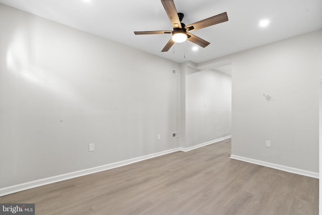 spare room with light hardwood / wood-style floors and ceiling fan