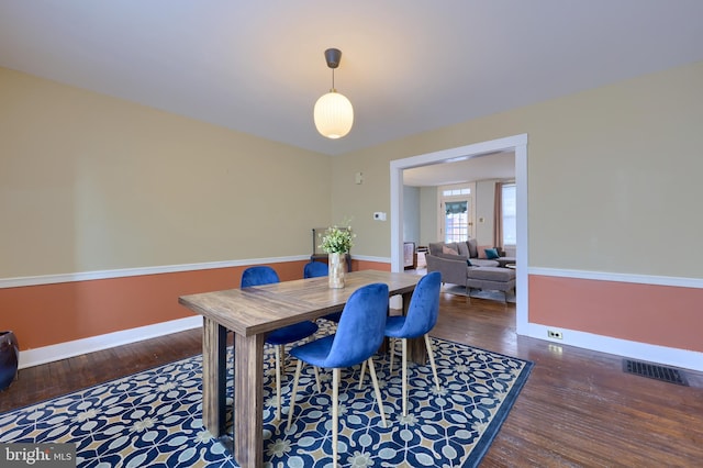 dining area with dark wood-type flooring