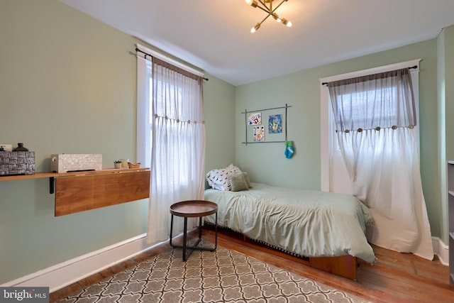 bedroom featuring multiple windows and hardwood / wood-style floors