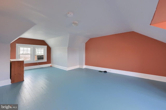 bonus room featuring lofted ceiling, dark hardwood / wood-style floors, and cooling unit