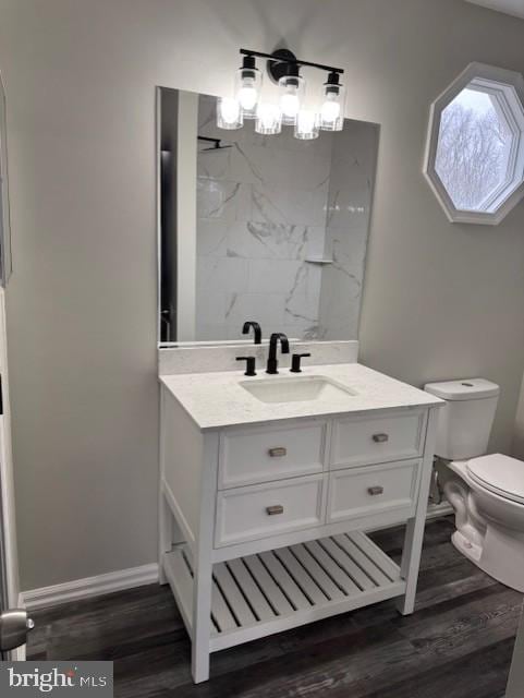 bathroom featuring vanity, toilet, and wood-type flooring