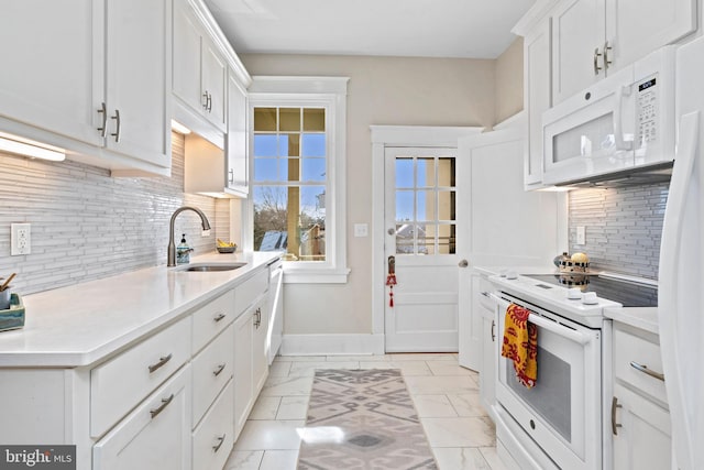 kitchen with white appliances, white cabinets, marble finish floor, light countertops, and a sink