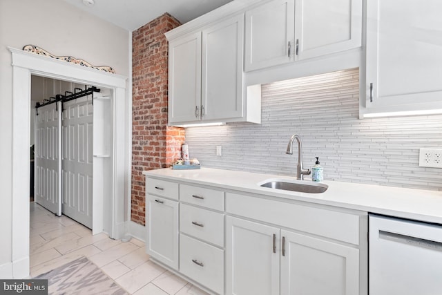 kitchen with a sink, white cabinetry, light countertops, dishwasher, and tasteful backsplash