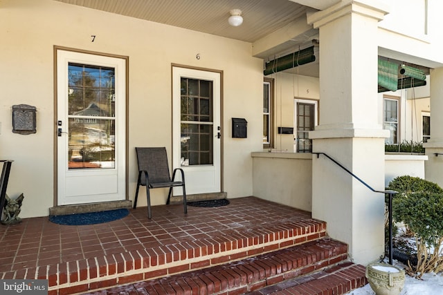 entrance to property with stucco siding