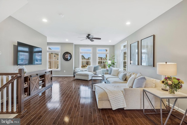 living room featuring dark hardwood / wood-style floors and ceiling fan