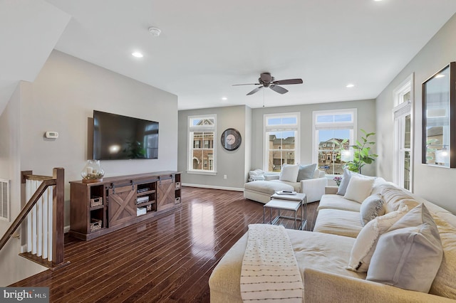 living room featuring dark hardwood / wood-style floors and ceiling fan