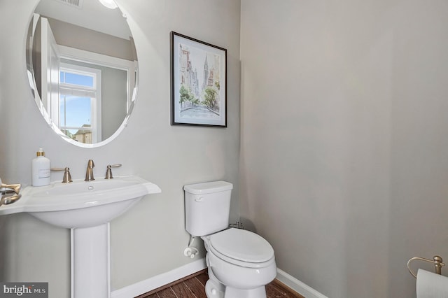 bathroom with sink, toilet, and hardwood / wood-style floors