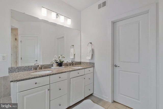 bathroom featuring tile patterned flooring and vanity