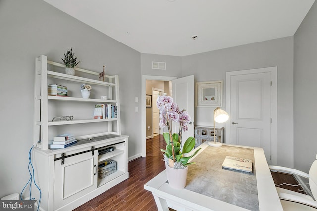 home office with dark hardwood / wood-style floors