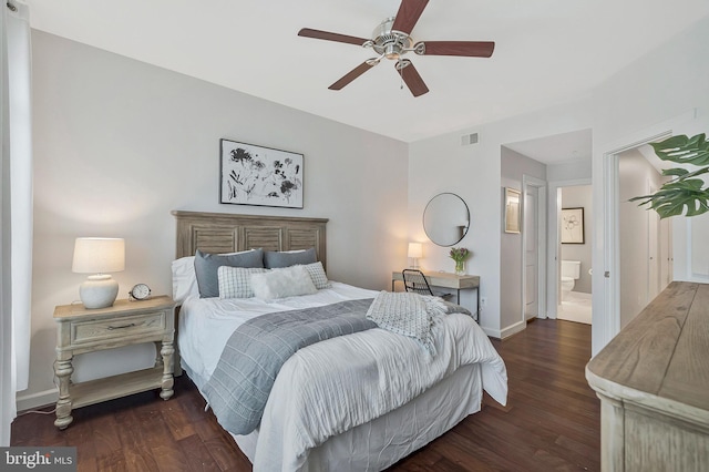 bedroom featuring connected bathroom, dark hardwood / wood-style floors, and ceiling fan