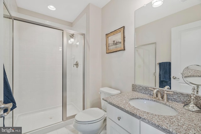 bathroom with vanity, an enclosed shower, and toilet