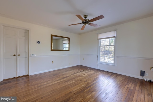 spare room featuring ceiling fan and dark hardwood / wood-style flooring