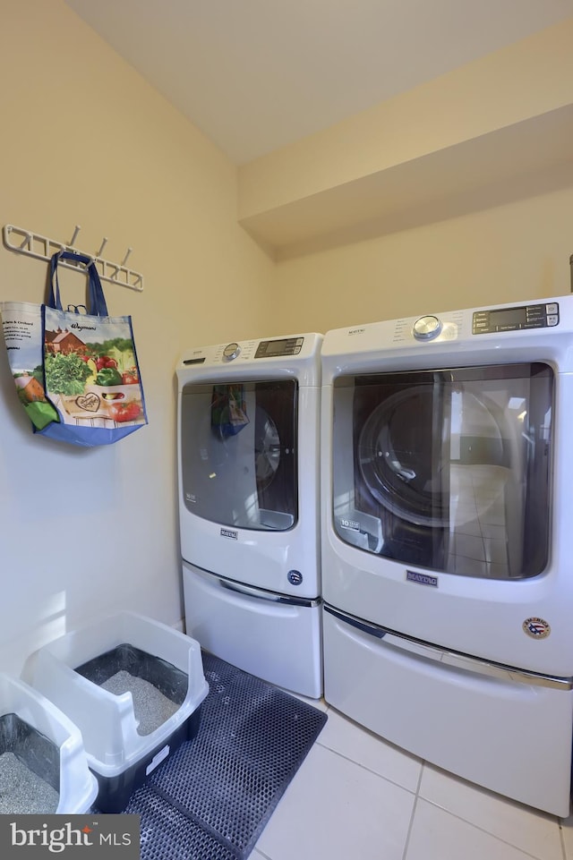 laundry room with tile patterned flooring and washer and dryer