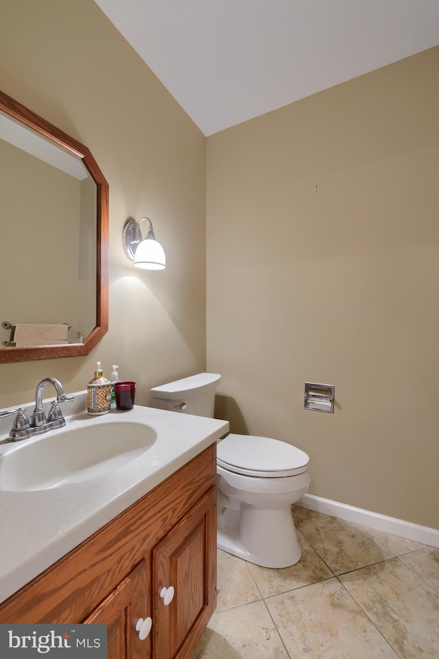 bathroom featuring vanity, tile patterned floors, and toilet