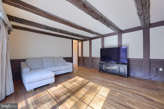 living room featuring beamed ceiling and wood-type flooring