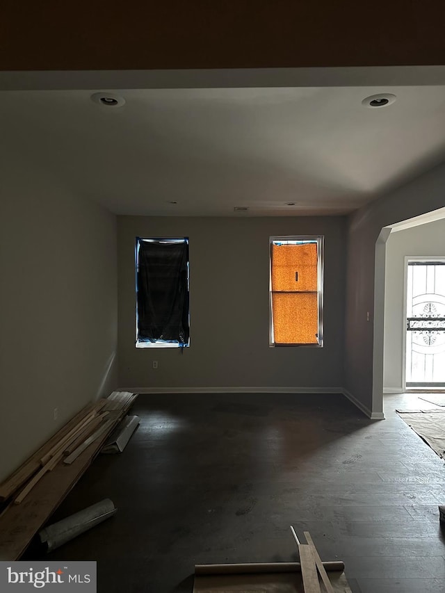 empty room with baseboards and wood finished floors