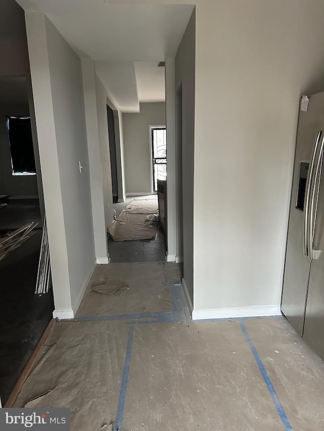 corridor featuring baseboards