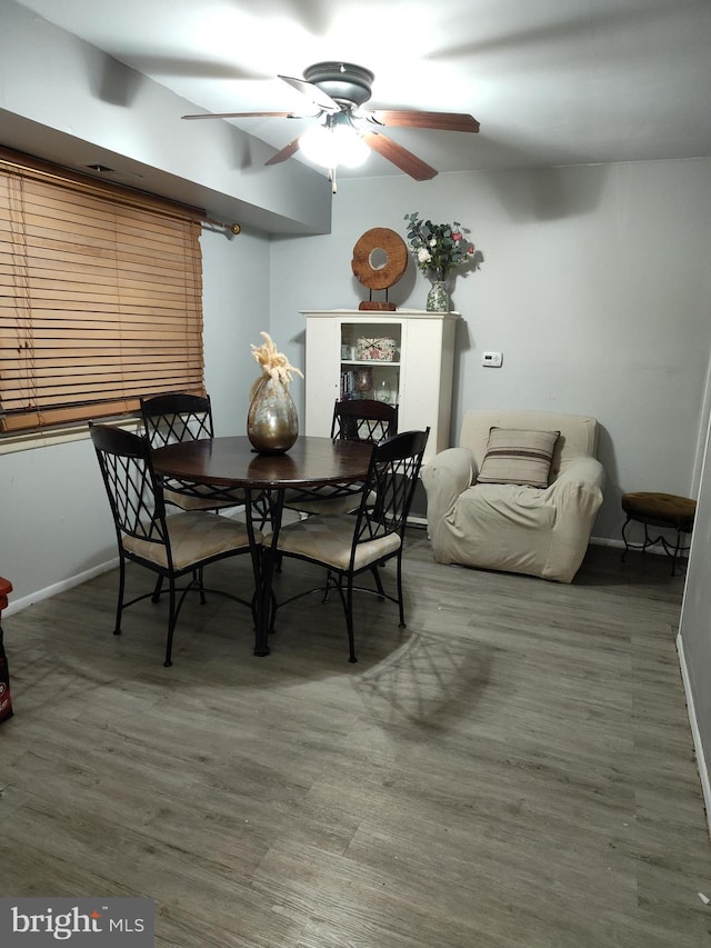 dining space featuring hardwood / wood-style flooring and ceiling fan