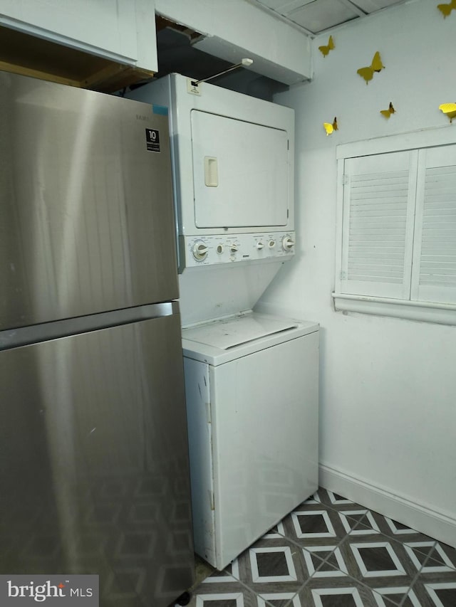 laundry room with stacked washer / dryer