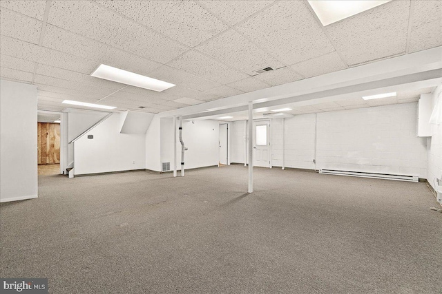 finished basement featuring a drop ceiling, baseboard heating, carpet, and visible vents