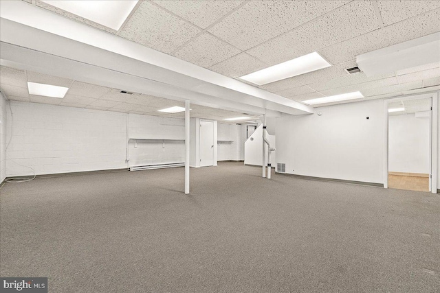 finished below grade area featuring carpet floors, visible vents, and a drop ceiling