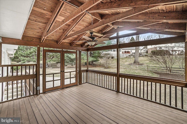 unfurnished sunroom featuring lofted ceiling with beams, wooden ceiling, and ceiling fan