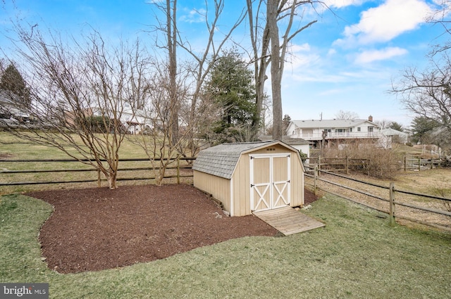 view of shed featuring fence