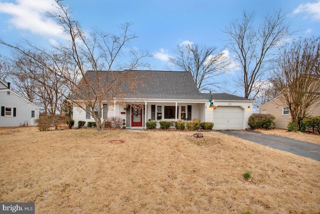 ranch-style home with a garage, a front lawn, and covered porch